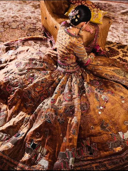 An artistic shot showcasing the incredible detail of a vintage-inspired lehenga from Delhi Vintage Co. The rich, earthy tones and intricate embroidery are a work of art.