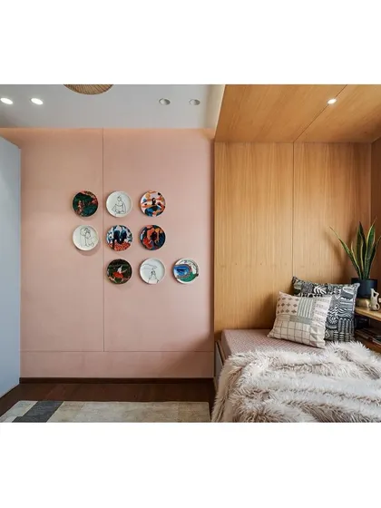 A collection of decorative plates adds a personal touch to the family room, turning a simple wall into a gallery of memories.