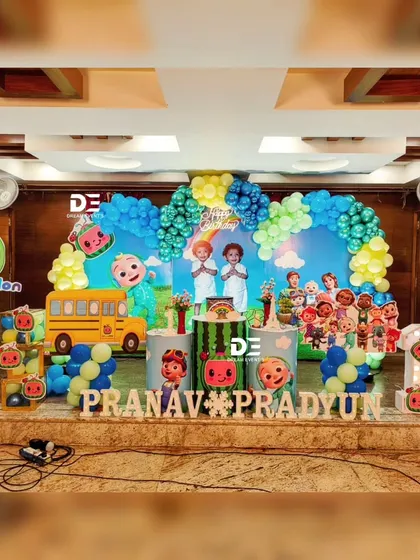 A vibrant Cocomelon party for twins Pranav and Pradyun. The stage is filled with their favorite characters, creating a fun and engaging setup for their joint celebration.