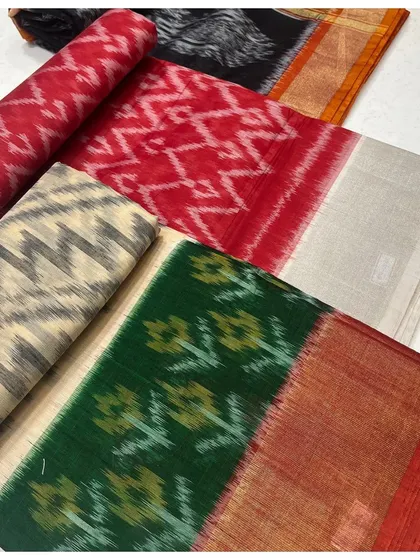 A selection of our vibrant Ikkat sarees. This image displays a range of colorways, from bold reds and greens to neutral tones, each featuring the distinctive blurred patterns of the Ikkat dyeing technique.