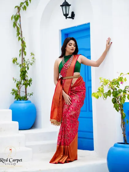 Actress Sonal Monteiro wearing a red patola print saree with a contrasting green halter blouse for Day 3 of 'Navataara'.