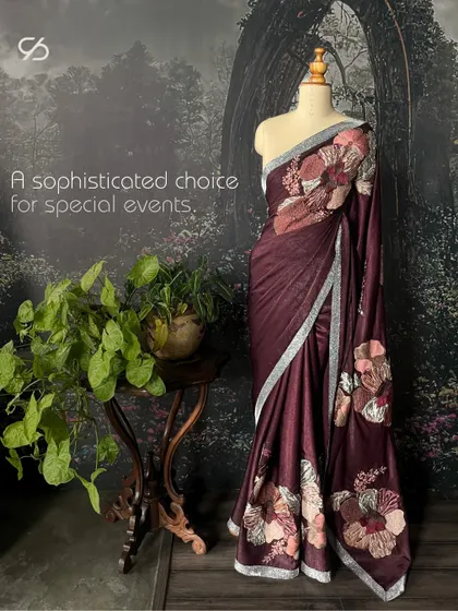 This brown suede saree with dramatic floral appliqué is a sophisticated choice for special events, blending modern texture with a traditional drape.
