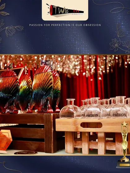 A display of premium Patron tequila and unique rainbow-colored glassware at an awards night.