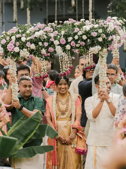 The bride's entrance under a 'phoolon ki chadar' made of fresh flowers is a truly spectacular moment. We custom design these canopies to match the bride's attire and the overall wedding decor.