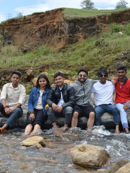 The whole gang sitting on a log across the stream. It's a great photo that captures the spirit of our group.