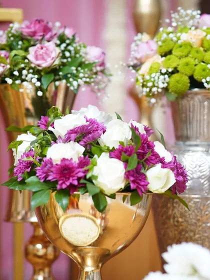 An intimate half-saree function where personalized decor helps weave stories and emotions. The backdrop of fresh flowers and traditional props created a beautiful setting for capturing all the giggles and smiles.
