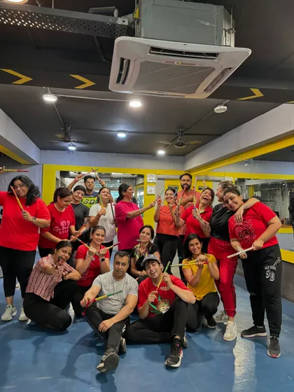 The entire fam posing with dandiya sticks after our Navratri 2024 session.