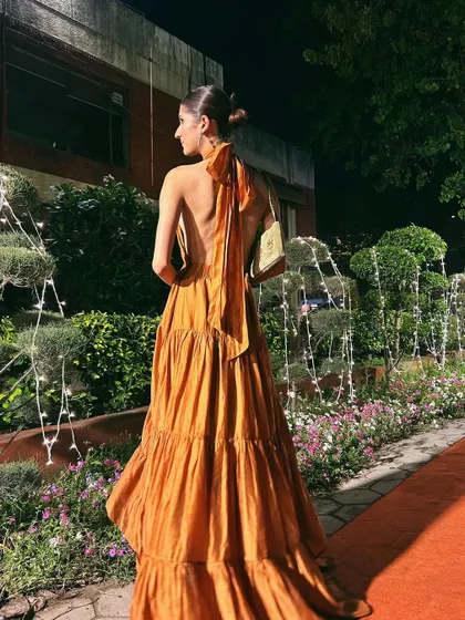 The full backless view of the halter dress. It's a statement piece that is both sophisticated and daring.
