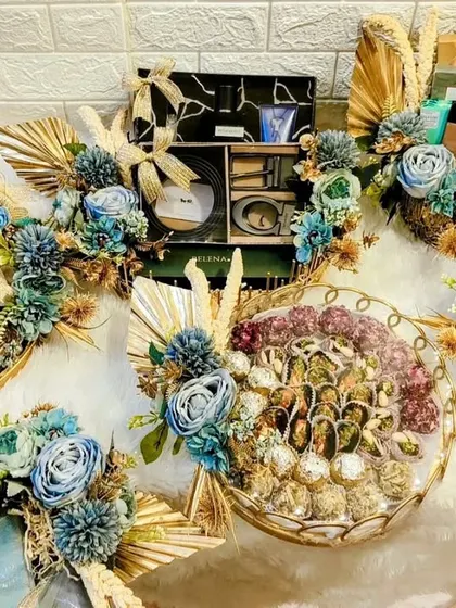 An array of festive gift hampers all decorated in a stunning blue and gold color scheme. I can customize these for any occasion, from Diwali to weddings.