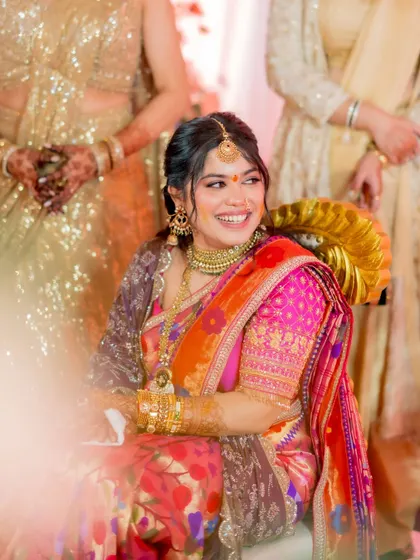 A candid photo capturing the joy of the ceremony. The bride's smile is infectious, and her radiant makeup look is perfect for these happy, unposed moments.