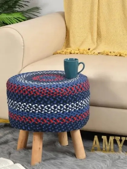 This jute stool woven with shades of blue, red, and white offers a subtle patriotic or nautical vibe. It's a sturdy and stylish seating option.