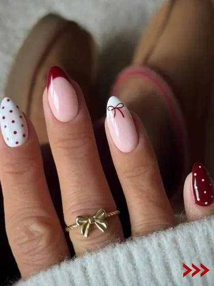 A chic and minimalist Christmas design. This set features a mix of polka dots, a simple bow, and a classic red French tip for a festive yet sophisticated look.