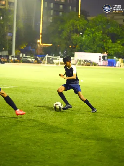 A player maintains his balance and control while being challenged for the ball.