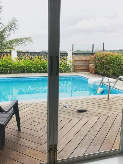 Looking out from the residence, this image shows how the terrace pool is framed as an extension of the living space. The sliding glass doors open directly onto the wooden deck, creating a seamless indoor-outdoor connection.