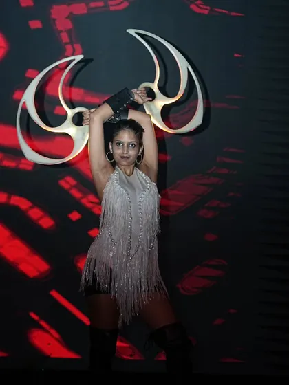 A powerful pose with my LED fans against a graphic background. The combination of the prop, costume, and backdrop creates a strong visual statement.