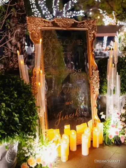 A grand, gold-edged mirror with custom calligraphy welcomed guests to the wedding reception. Surrounded by hundreds of candles, this entrance piece created a warm, elegant, and personal first impression.