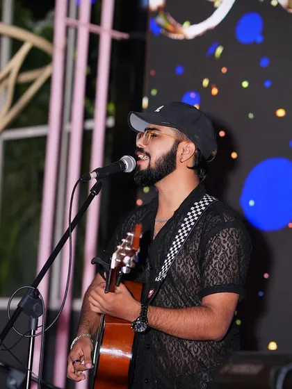 A shot of me in my element, connected to the music and the audience. Whether it's with a full band or just my guitar, my focus is always on delivering a performance filled with soul and energy.