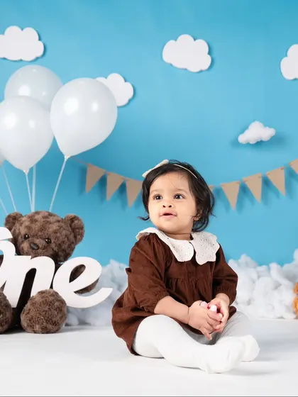 A sweet, simple portrait of the birthday girl against the sky backdrop. Her curious expression is just adorable.