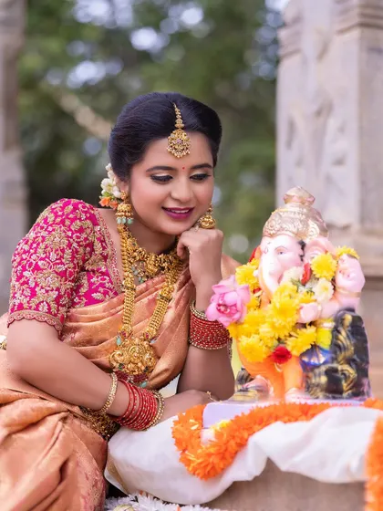 The rich gold of the saree complements the festive atmosphere perfectly.