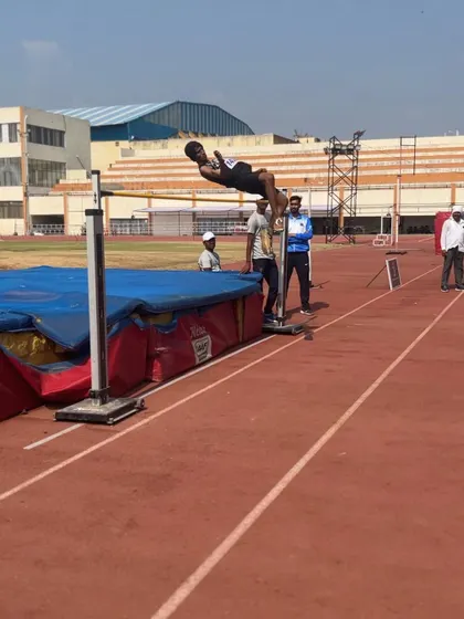 A high jumper clears the bar, showcasing the mind-blowing performances from Day 2 of TrackNights 2023.
