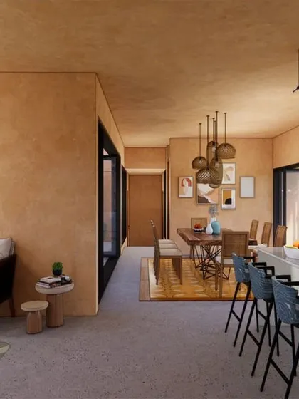 The seamless flow from the kitchen to the living and dining areas in Earth Abode, all oriented towards the outdoor spaces.