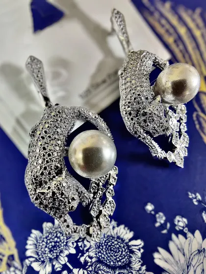 Unleash your wild side with these exquisite diamond-studded leopard earrings holding a lustrous pearl. This is a perfect example of my Feng Shui inspired collection, bringing together power and elegance in one statement piece.