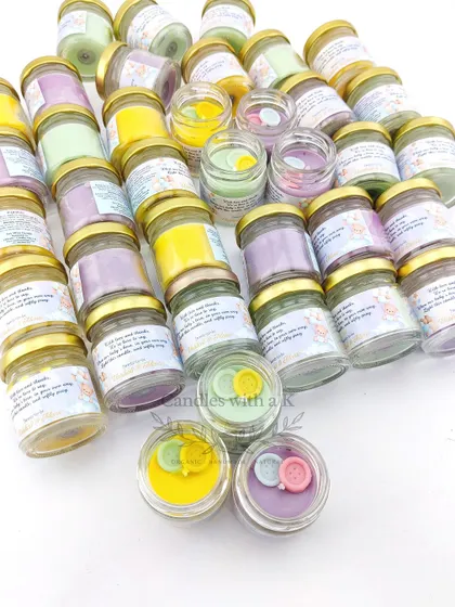 A beautiful assortment of our teddy bear themed baby shower candles, customized in lilac, yellow, and green with cute button toppers.