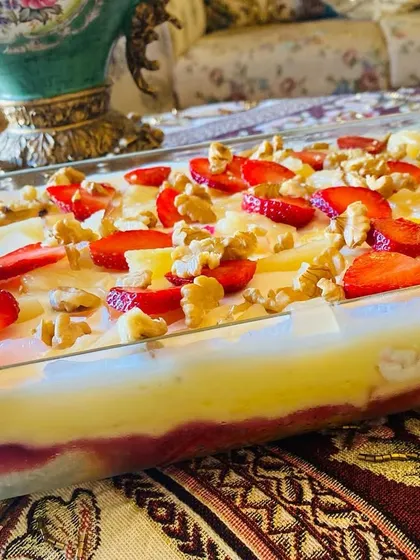 My fruit trifle is layers of pure happiness. I use moist cake, fresh strawberries, pineapple, crunchy walnuts, and a creamy custard to make this refreshing dessert.