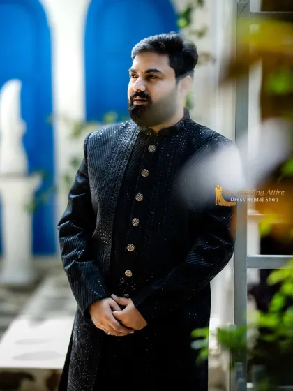 A side profile of the black textured sherwani, showing its excellent fit and structure. It's designed to look sharp from every angle.