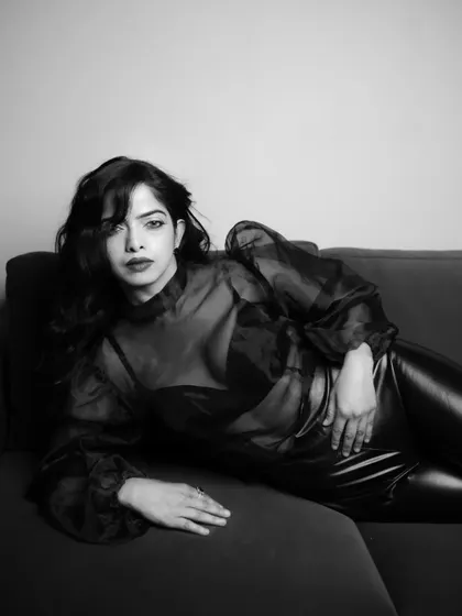 Another reclining pose, this time with a direct look to the camera. This shot feels both vulnerable and powerful, a testament to the moody atmosphere we created.