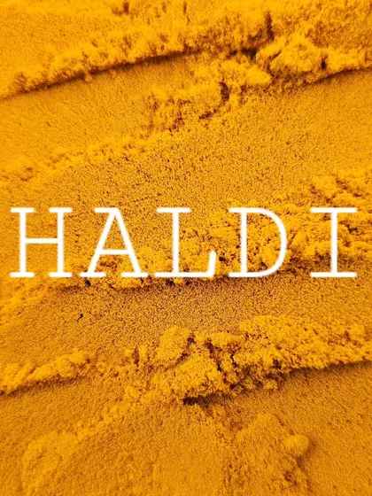 The word 'Haldi' over a bed of turmeric. It's more than a spice; it's a part of our identity.