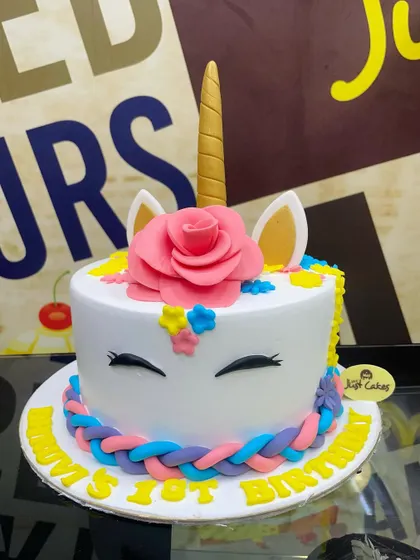 A sweet 2kg unicorn cake for a first birthday, with a braided fondant mane and a golden horn.