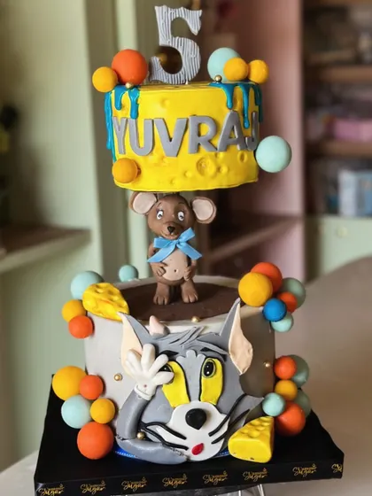 The chase is on! This playful Tom & Jerry inspired cake features a gravity-defying top tier and is all about mischief, fun, and lots of flavor for a classic cartoon lover.