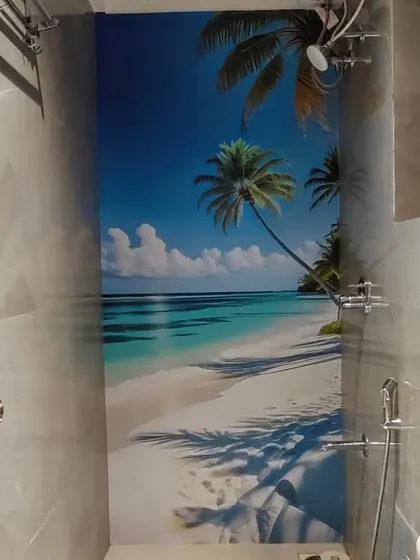 This is a peel-and-stick wallpaper with a tropical beach scene installed directly over tiles in a shower area. It's a great way to update a bathroom without major renovation.