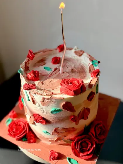 A rustic and romantic cake with hand-piped red roses. The textured frosting gives it a charming, artisanal feel, perfect for a heartfelt celebration.