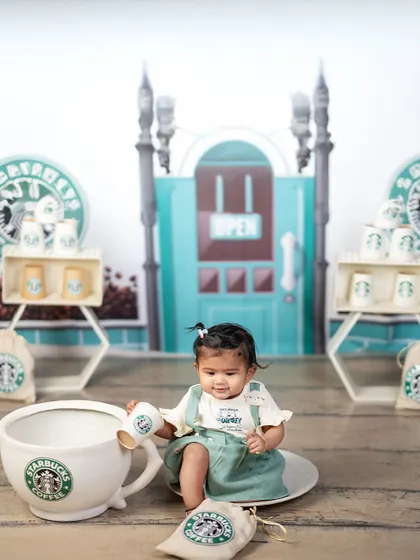 A giant cup of coffee for a tiny barista. This playful shot adds a fun twist to the Starbucks theme, showing the creative props we use to make shoots special.