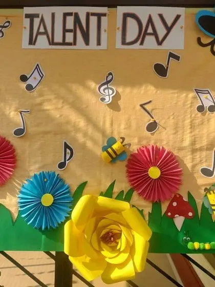 A colorful bulletin board decorated for Talent Day, filled with paper crafts made by the children.