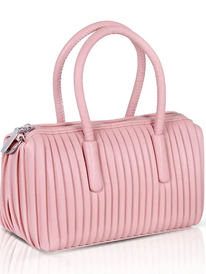 An angled shot of the pink handbag, showing its shape and texture.