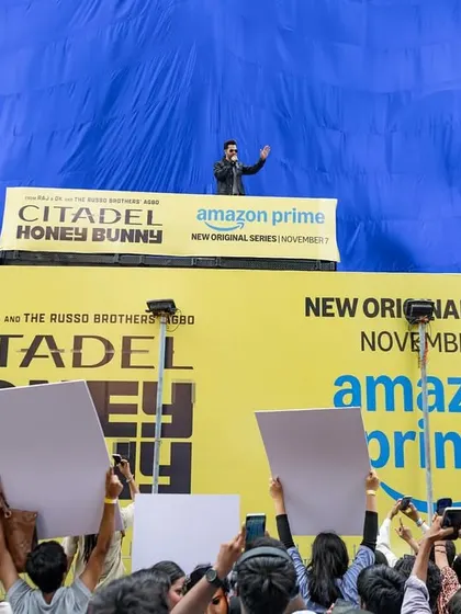 A wide angle to show the scale of the Amazon Prime event and the connection between the celebrity and the fans.