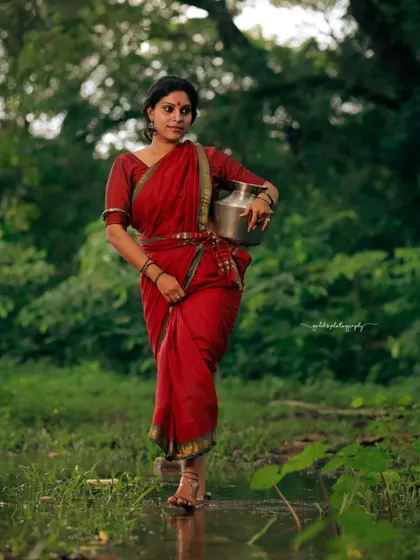 A rustic, village-themed series inspired by the movie 'Kanthara'. The model is styled in a simple red saree, captured in a natural, watery landscape to evoke a sense of raw, earthy beauty.