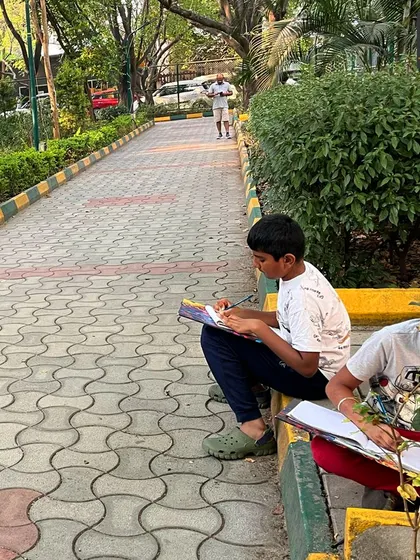 A student practices one-point perspective by sketching a park pathway. This exercise helps build an intuitive understanding of how to create depth and distance in a drawing.