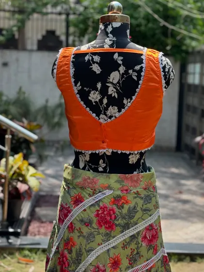 The back of the orange blouse, showing the simple yet elegant design.