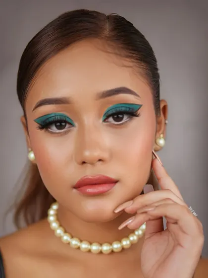 A confident pose that highlights the symmetry and precision of the winged eyeshadow, a testament to our technical skill.