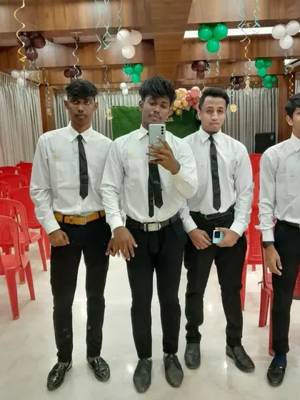 A group of my young stewards in uniform, taking a moment before service begins in a banquet hall.