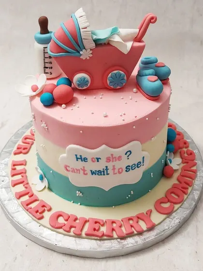 We build anticipation with this classic "He or She? Can't Wait to See!" gender reveal cake. Pink and blue stripes, a baby carriage, and tiny booties create a sweet and traditional design for a baby shower celebration.