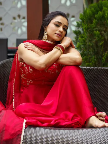 Capturing the beautiful flow and movement of this red Anarkali suit. This kind of dynamic shot is perfect for showcasing festive or wedding attire.