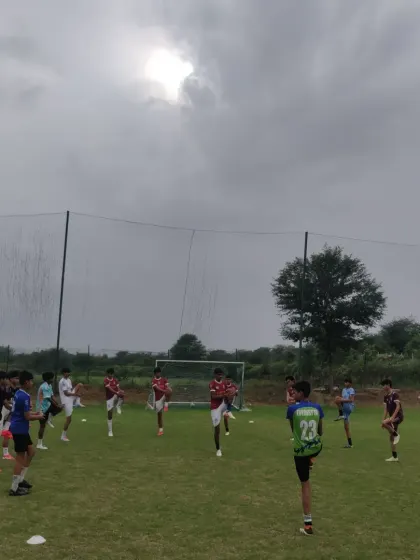 Players warming up with stretches at the start of a training session. Proper preparation is key to performance and injury prevention.