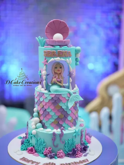 A full view of the three-tiered mermaid cake, complete with coral, seahorses, and a beautiful mermaid sitting in her grotto.
