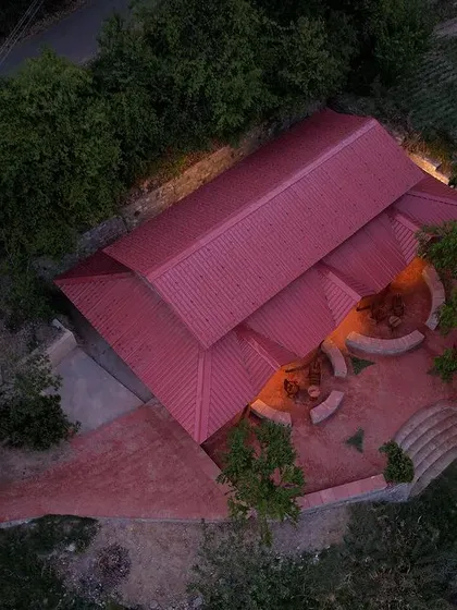 **Sargakhet Handicraft Centre, Uttarakhand:** An aerial view of the restored centre, showing how the new red roof and landscaped brick pathways sit gently on the hilly terrain. The design respects the site's natural beauty while creating a functional public space.