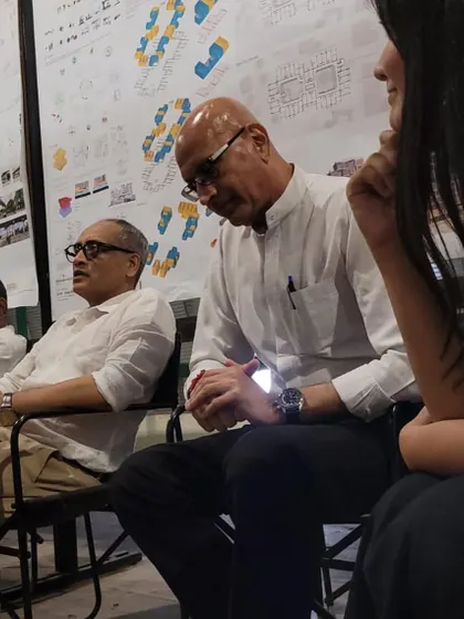 Listening intently during a student review. My role is to help students navigate the complex path from a conceptual idea to a resolved architectural proposition.